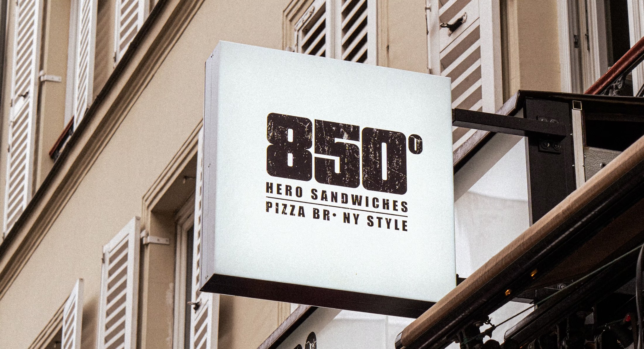 850° Oberkampf – illuminated projecting sign with the distressed 850° Hero Sandwiches, Pizza BR NY Style logo, logo by Jon Filin