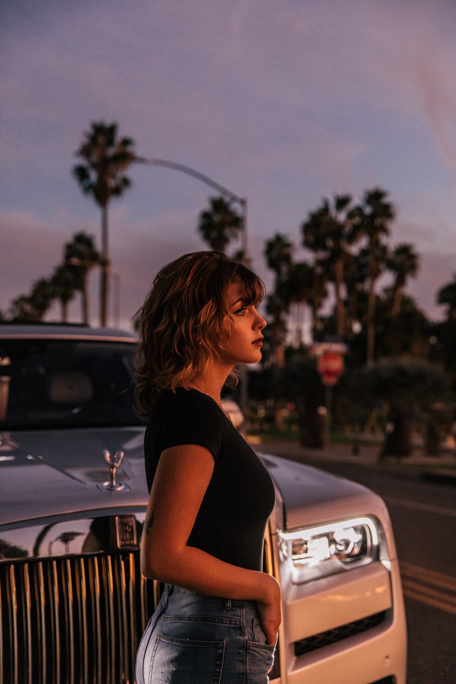 Rolls-Royce Cullinan – young woman in profile against the grille under Beverly Hills palm trees at dusk, art direction and photo Jon Filin